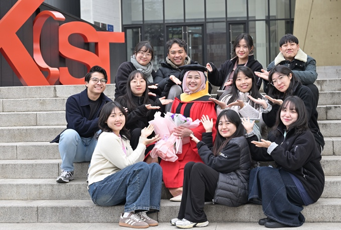 Lab group photo celebrating a graduation